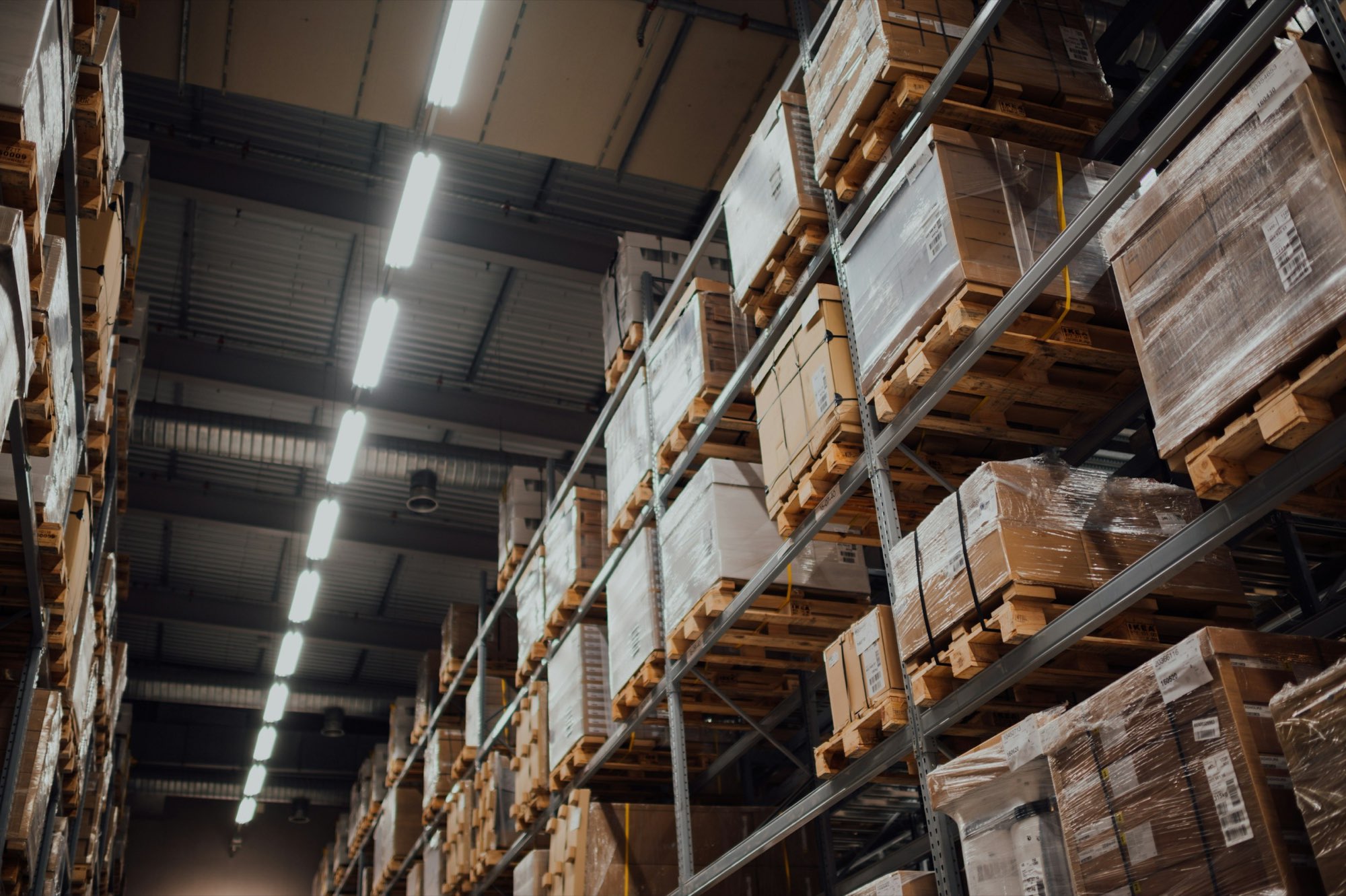 Cardboard cartons stacked on racking in a distribution warehouse